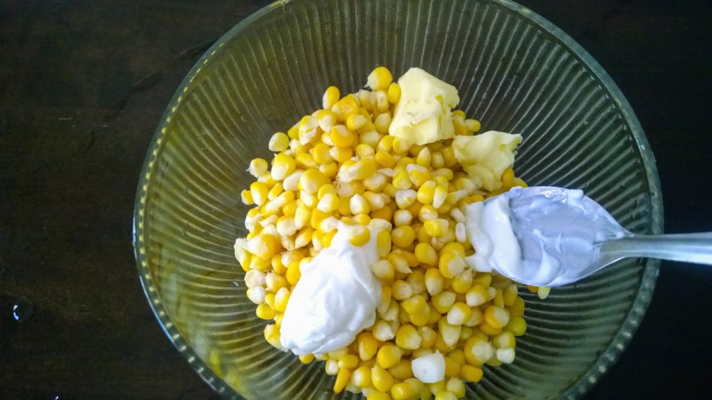 Butter and cheese to make cup corn