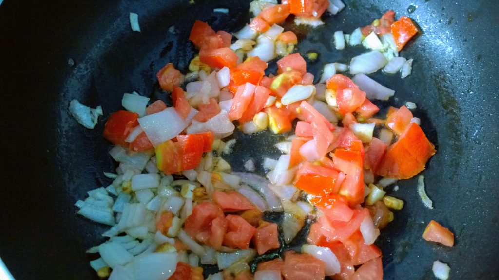 Garlic, onion and tomato getting fried