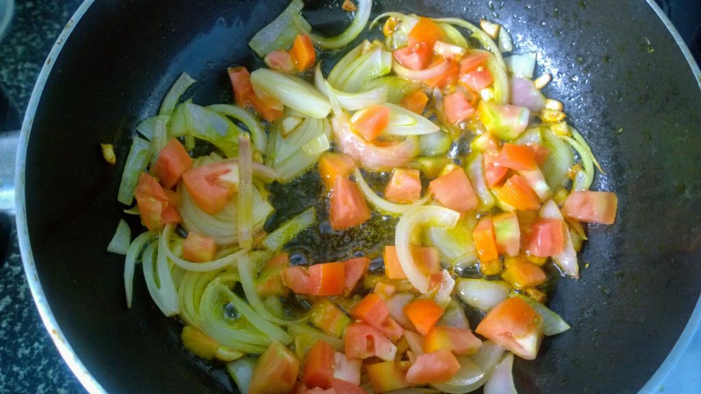 Tomato, onion and garlic in hot oil.