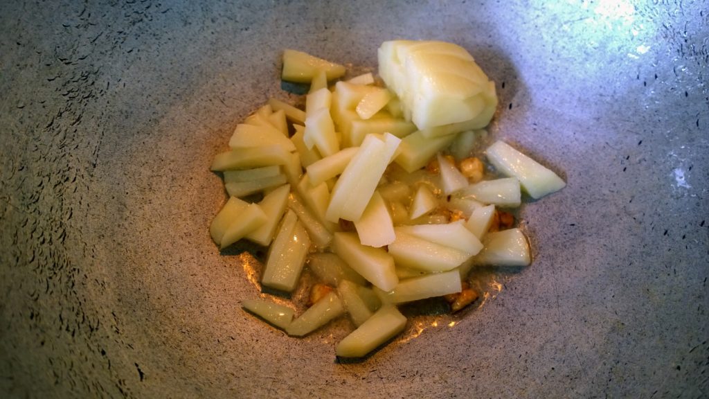 Potato into hot oil for frying