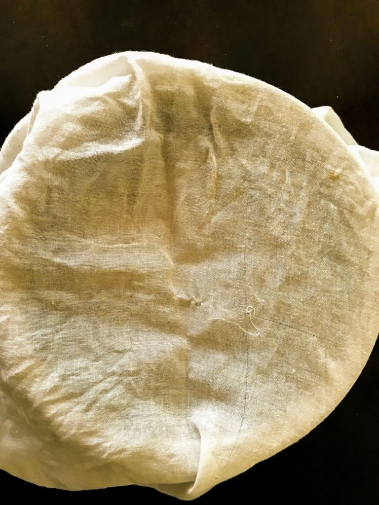 Dough covered in muslin cloth