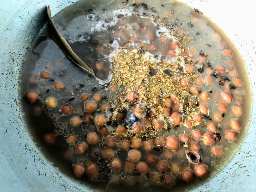 Adding spices to chana