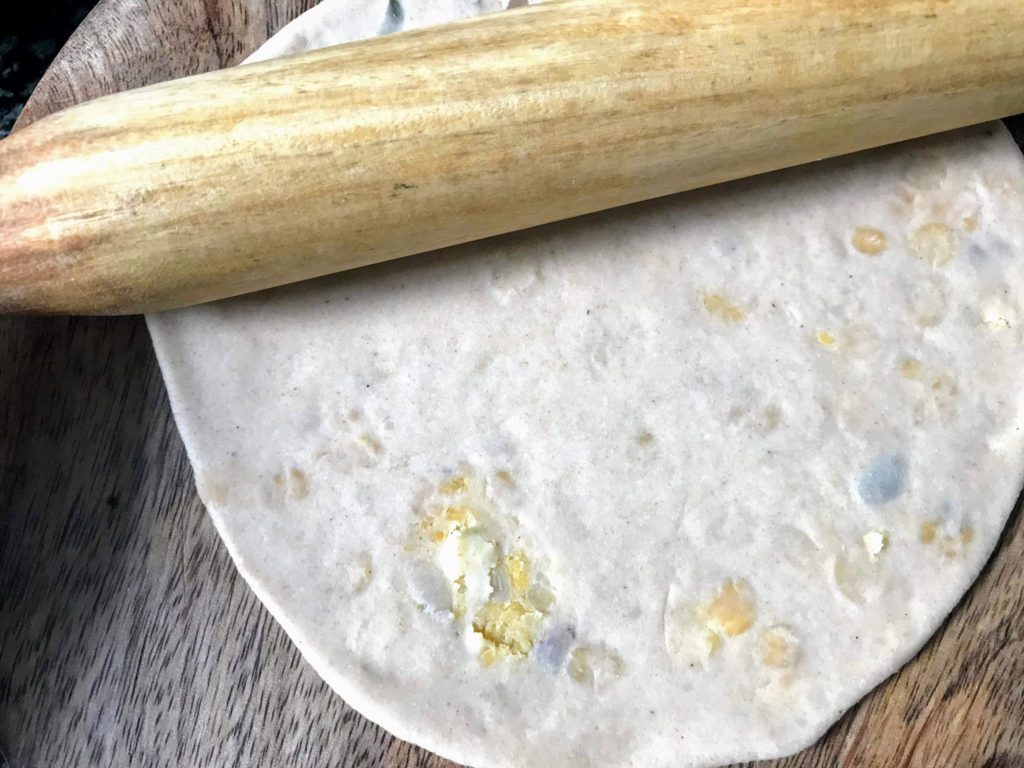 Rolling dough to paratha