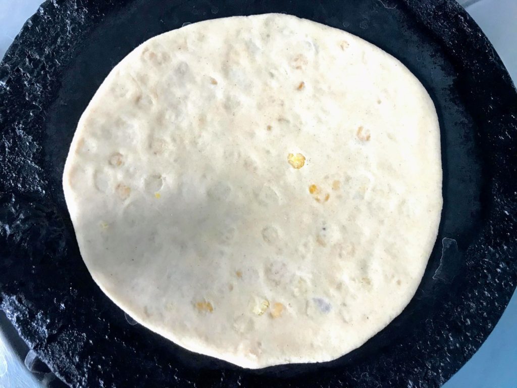 Cooking paratha on tawa