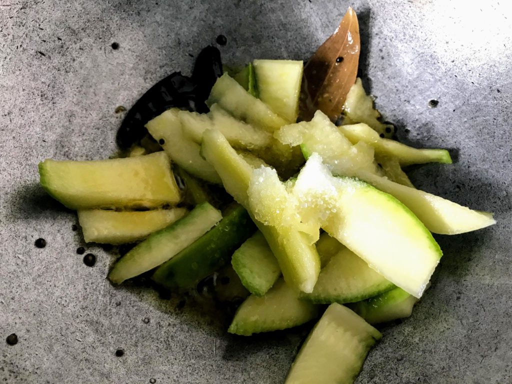 Raw mango cut into wedges.