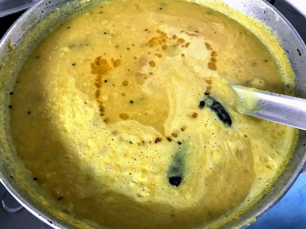 Adding ghee to dal