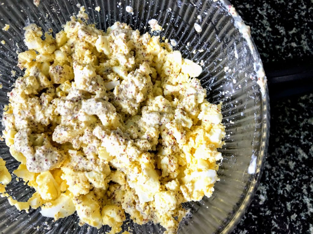 Mustard paste added to mashed egg