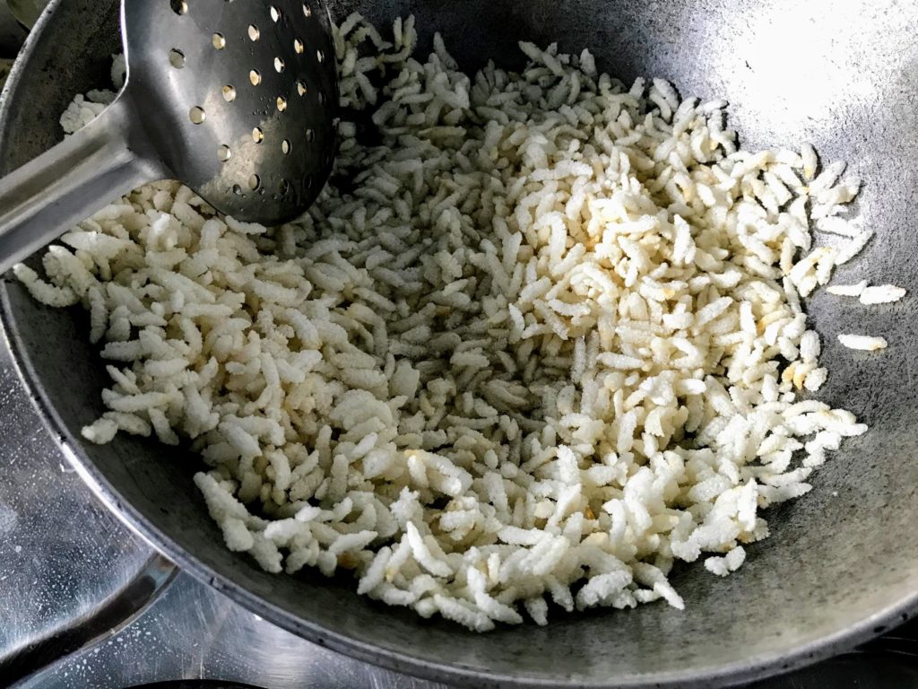 Deep frying flattened rice