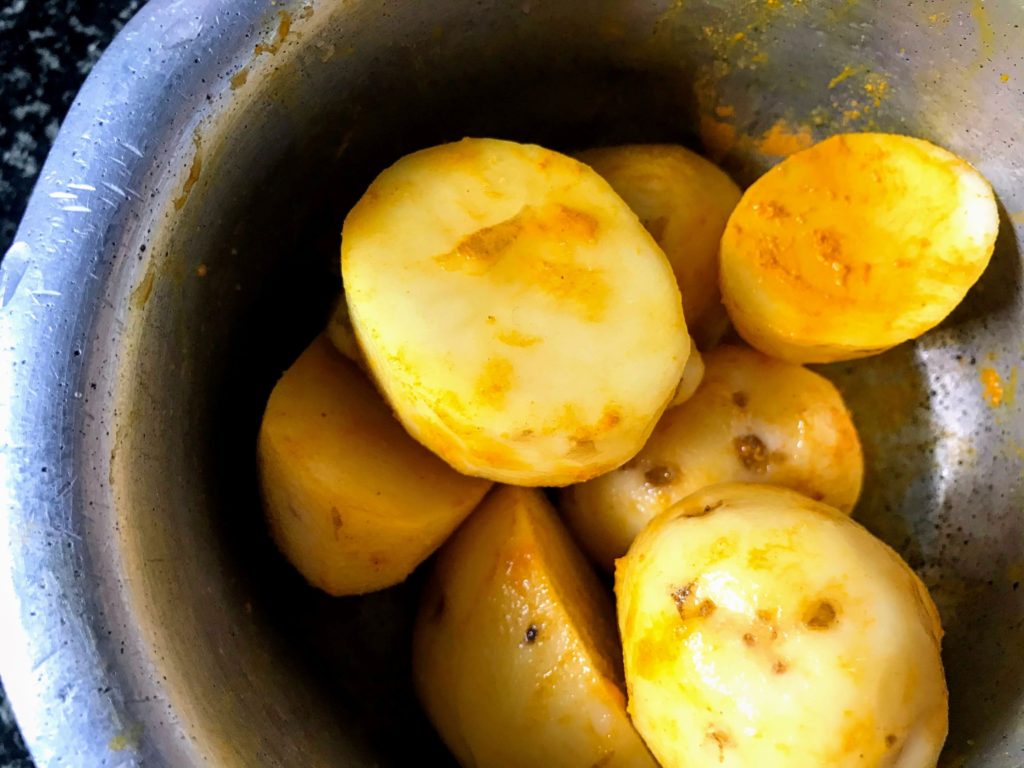 Potato rubbed with turmeric powder and salt