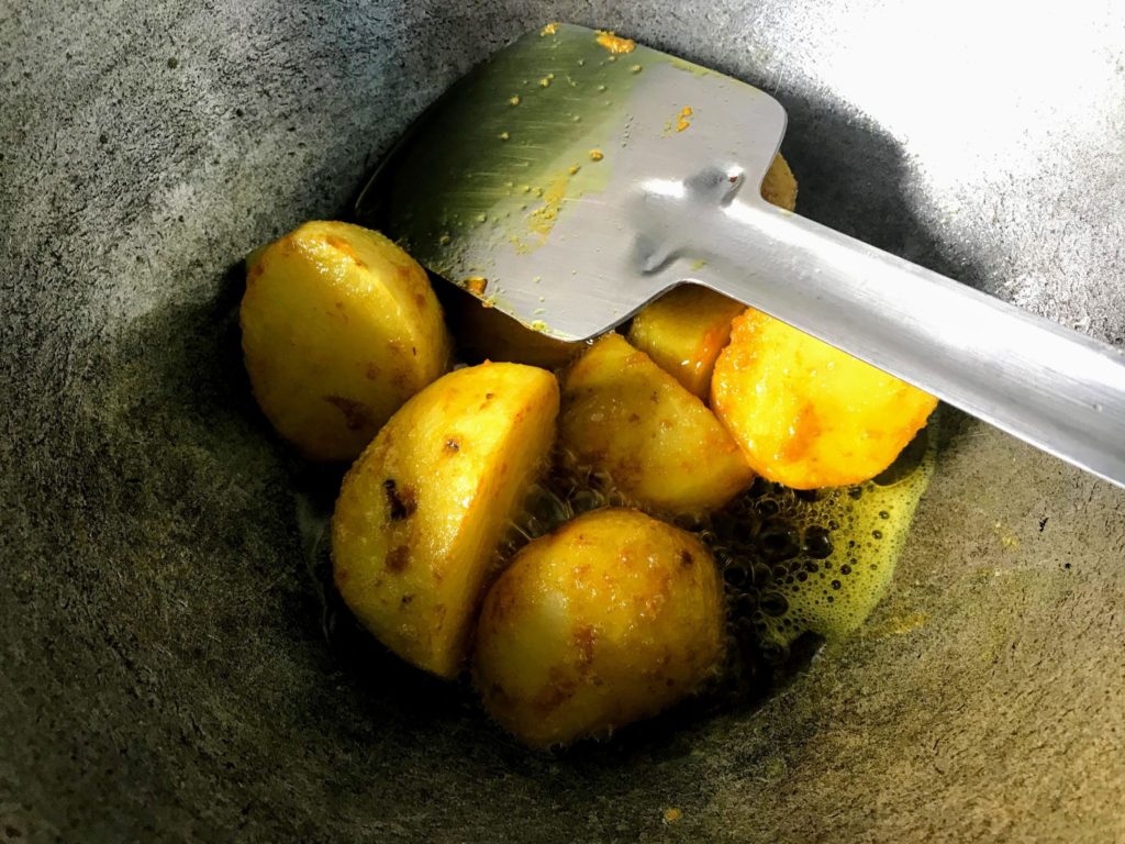 Frying potatoes.