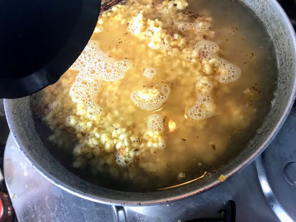 Adding water to dal.