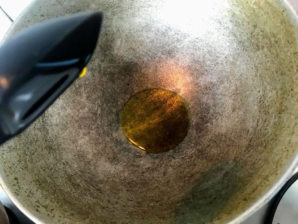 Adding oil into a wok