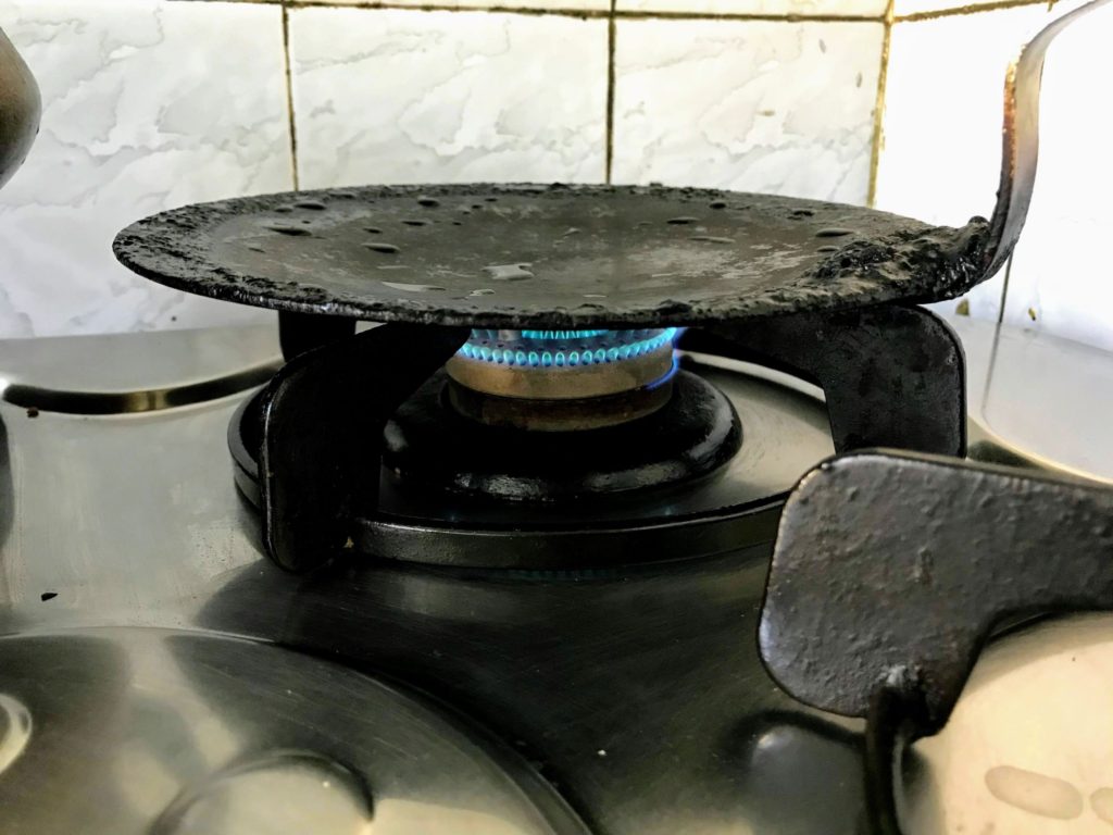 Heating tawa on stove