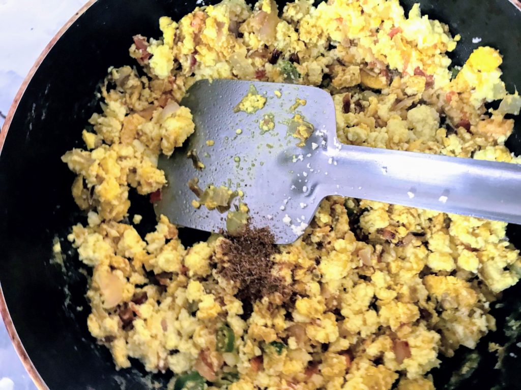 Adding garam masala into a dish