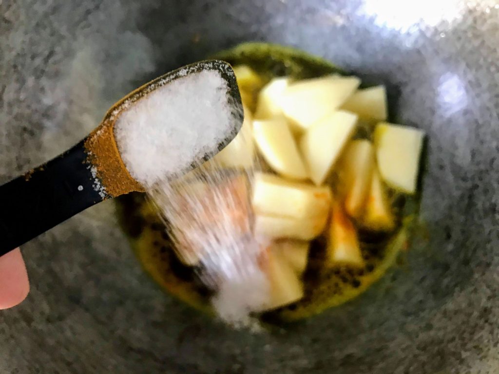 Adding salt to potatoes