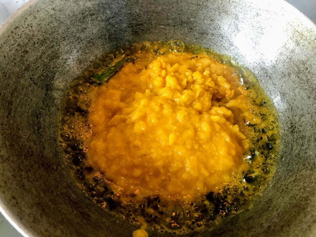 Adding cooked dal in a wok