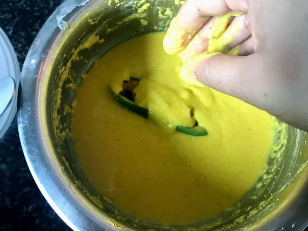 Dipping vegetable in batter for frying