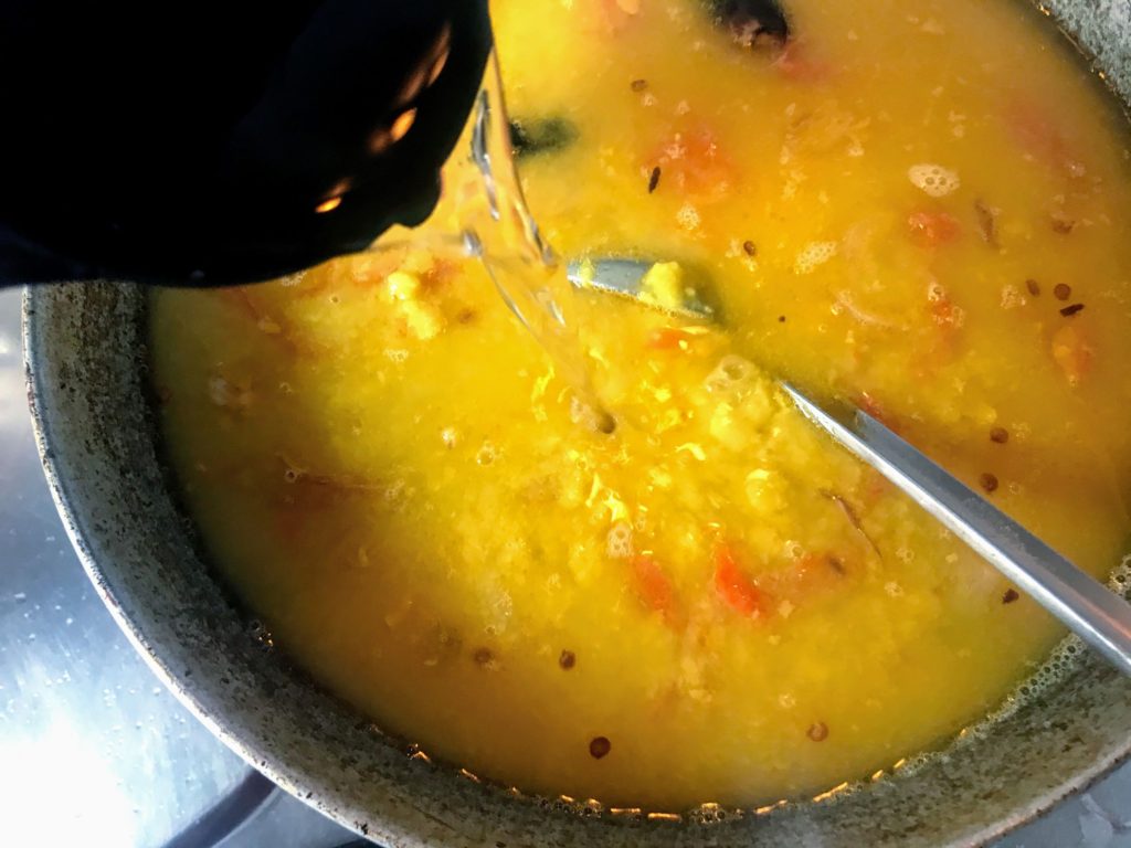 Adding water to dal