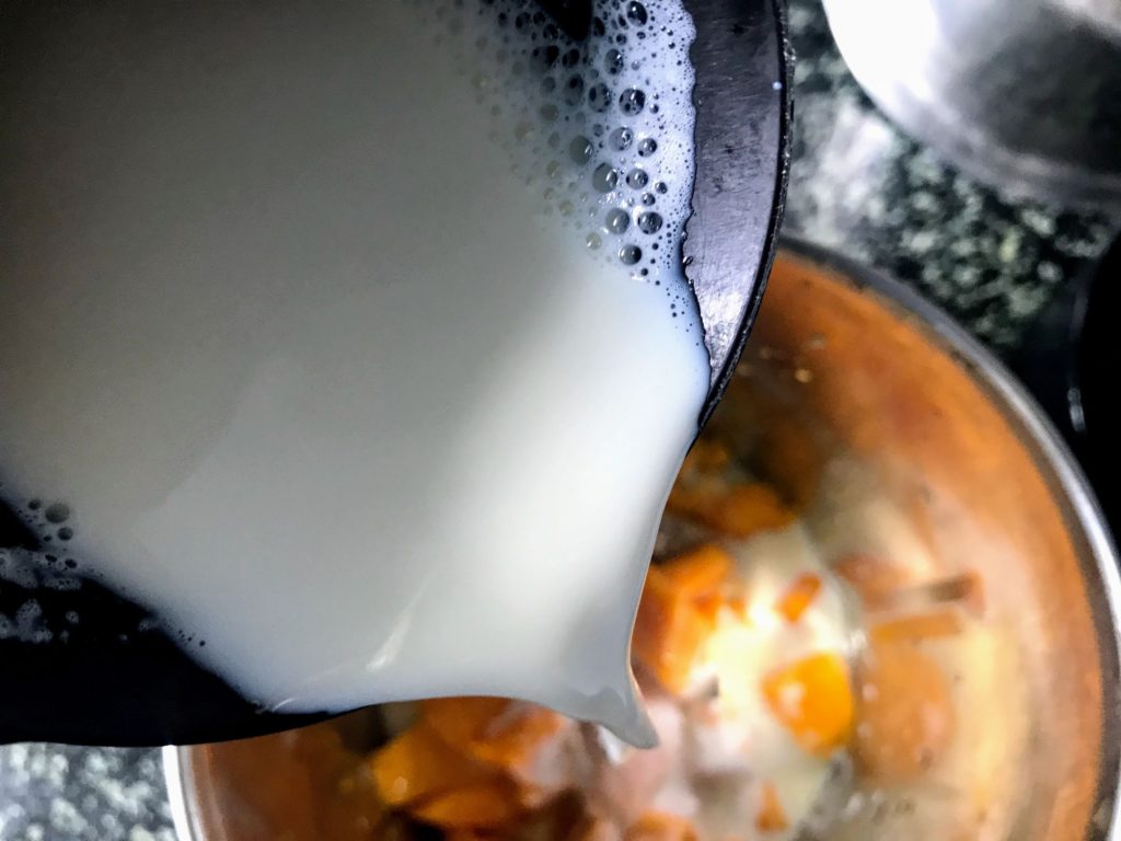 Adding milk to mango pieces