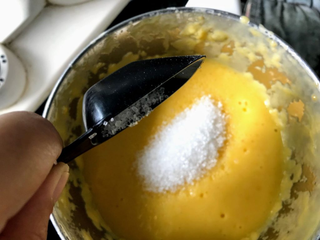 Adding sugar to Mango Coconut Milkshake