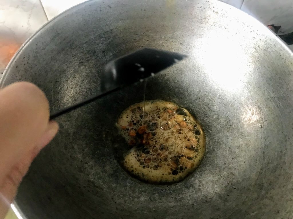 Adding oil into a wok