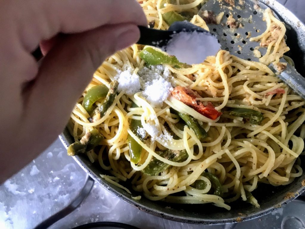 Adding salt to spaghetti
