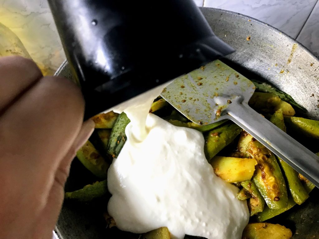 Adding curd to make Doi Potol