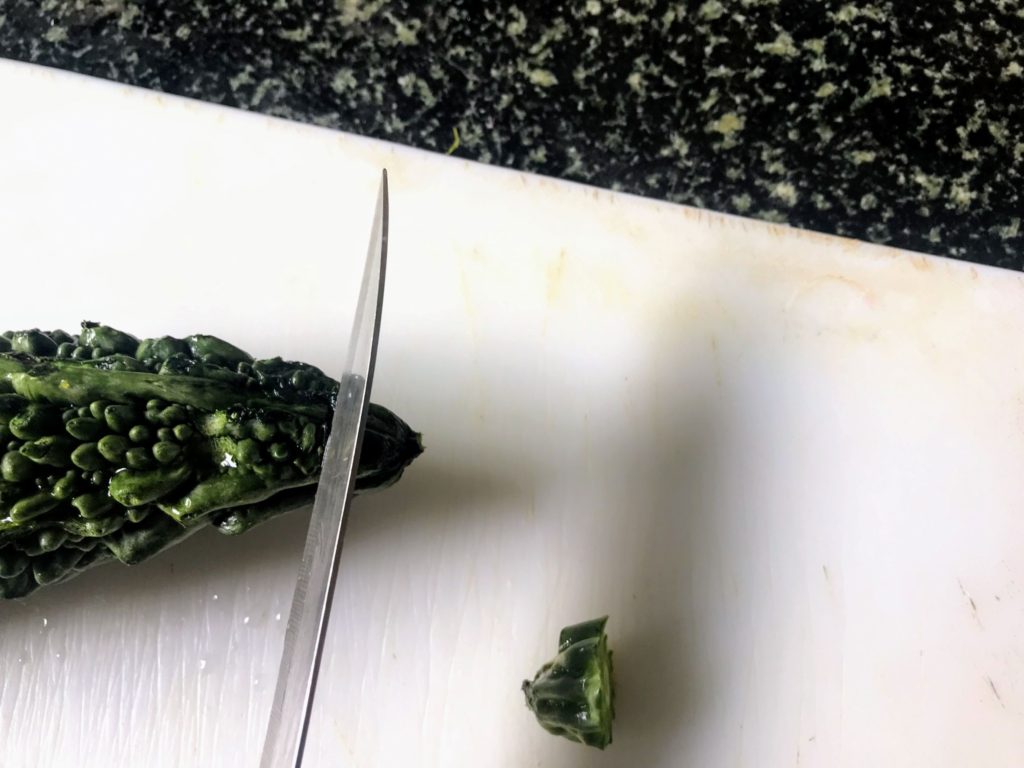 Trimming ends of bitter melon