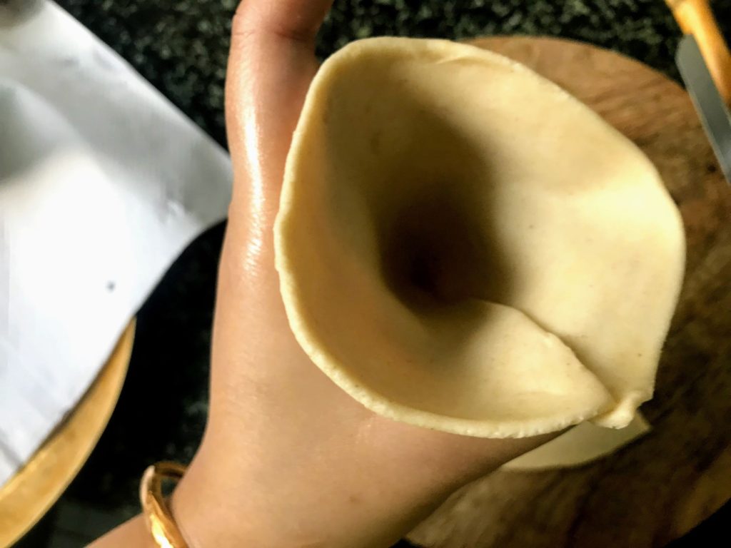 Dough edges joined to form funnel
