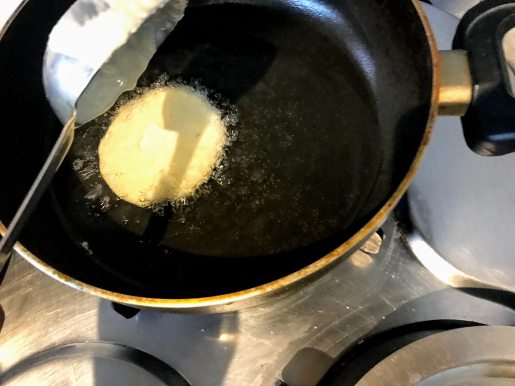 Pouring malpua batter in hot oil
