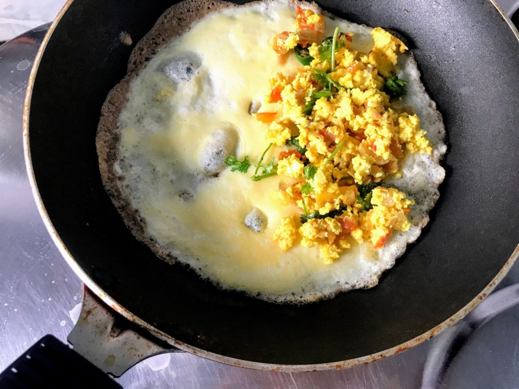 Fried crumbled paneer on omelette
