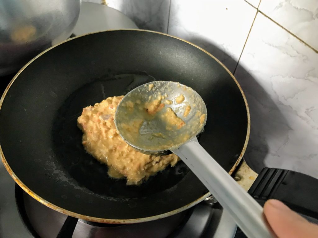 Spreading batter in a pan with a ladle
