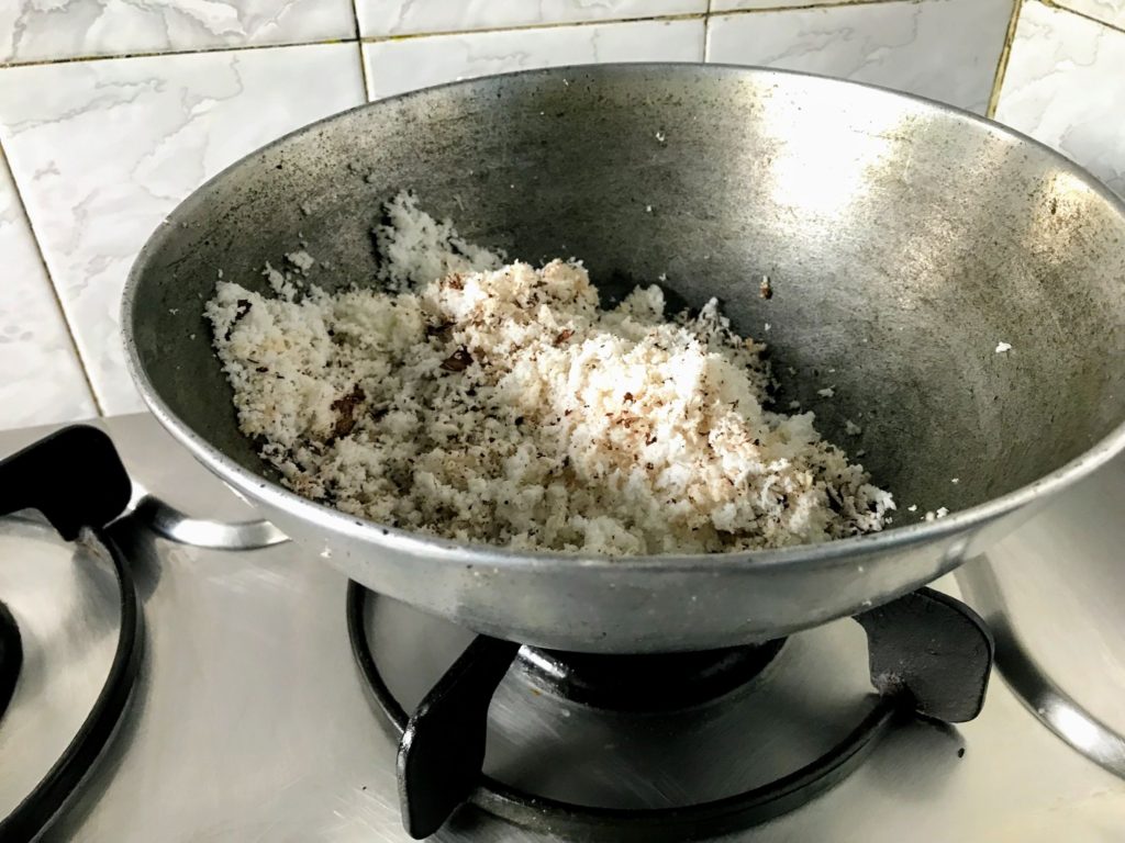 Grated coconut in a wok