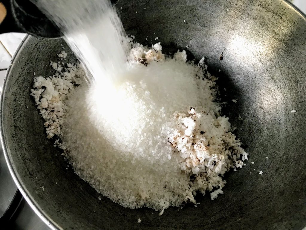 Sugar into grated coconut