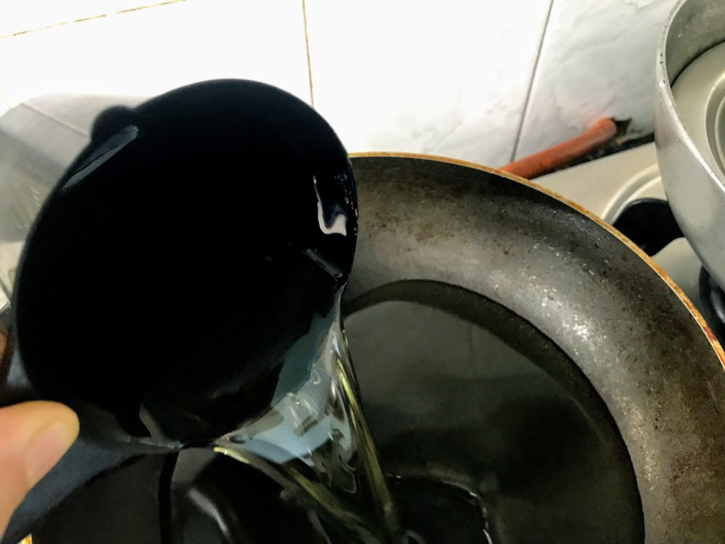 Adding oil in a pan