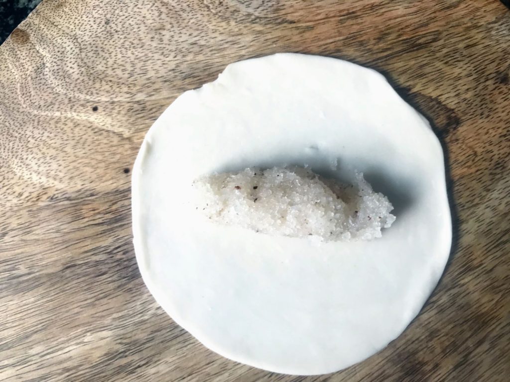 Coconut filling on flattened dough
