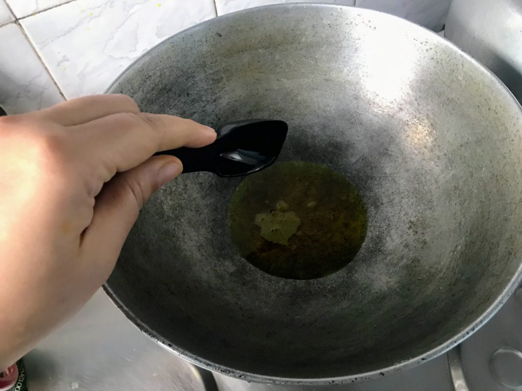 Adding oil into a wok