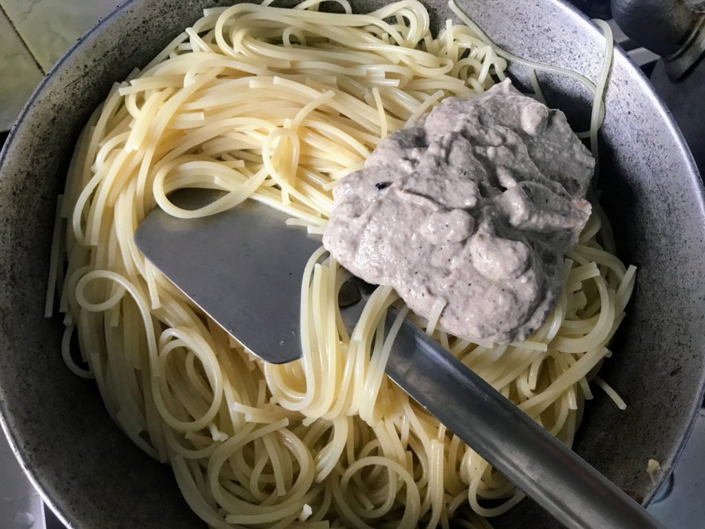 Cooking spaghetti with mushroom sauce