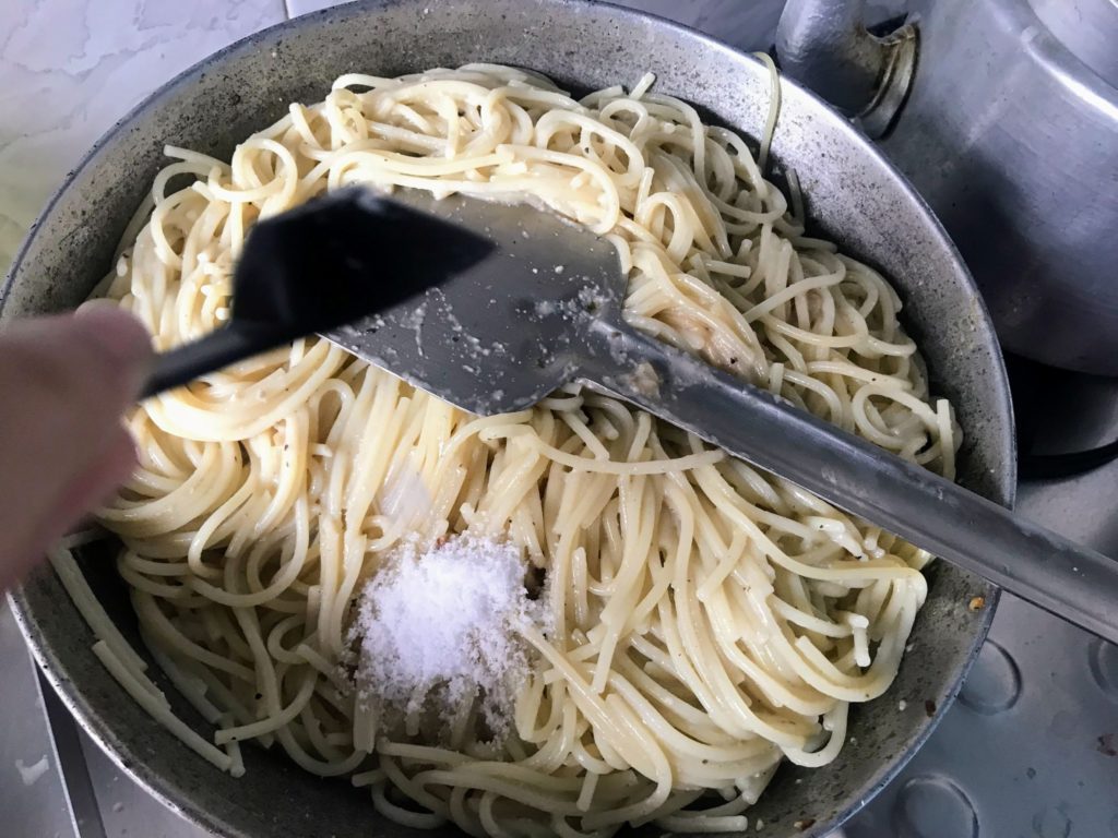 Adding salt to spaghetti