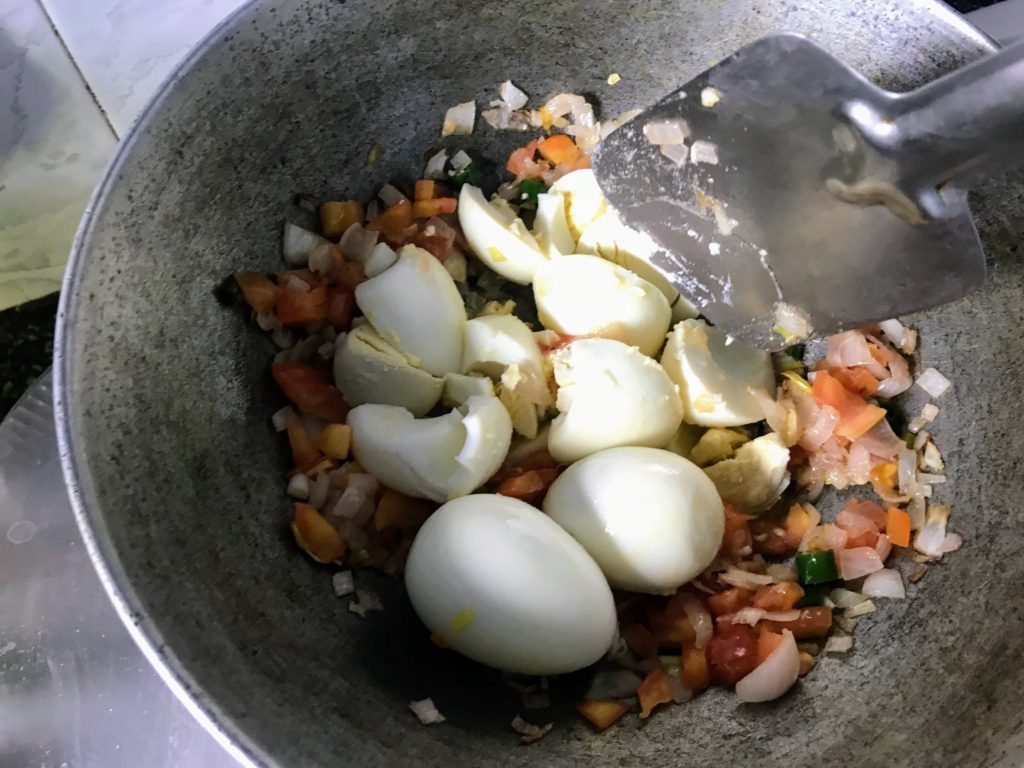 Breaking boiled eggs for frying