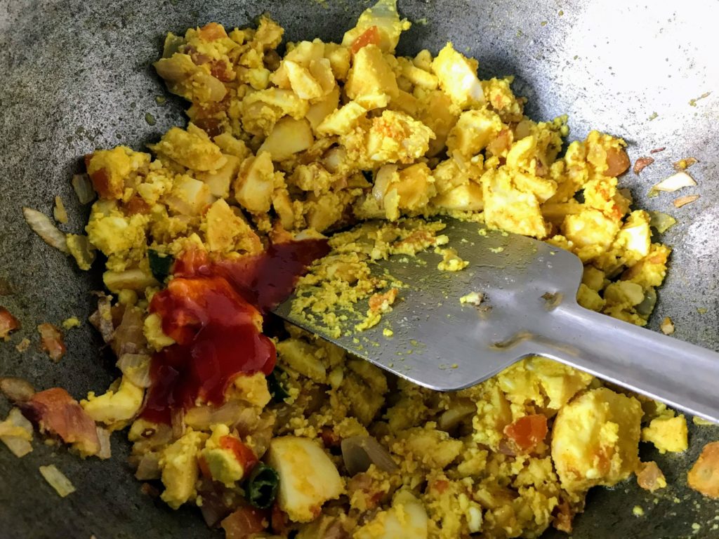 Adding sauce to make egg bhurji