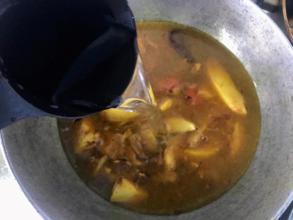 Adding water to make curry