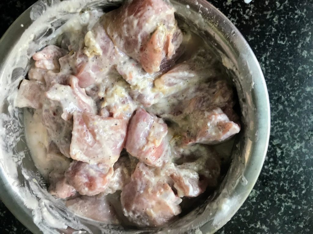 Chicken pieces marinating with curd and spices