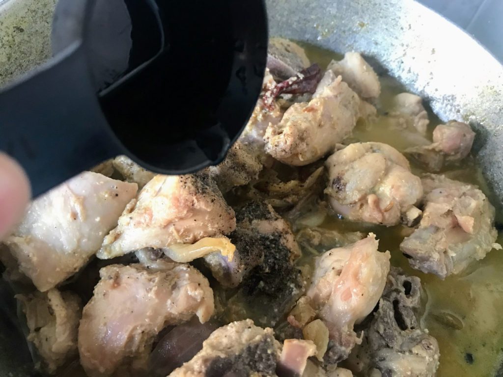 Adding kewra water on chicken curry