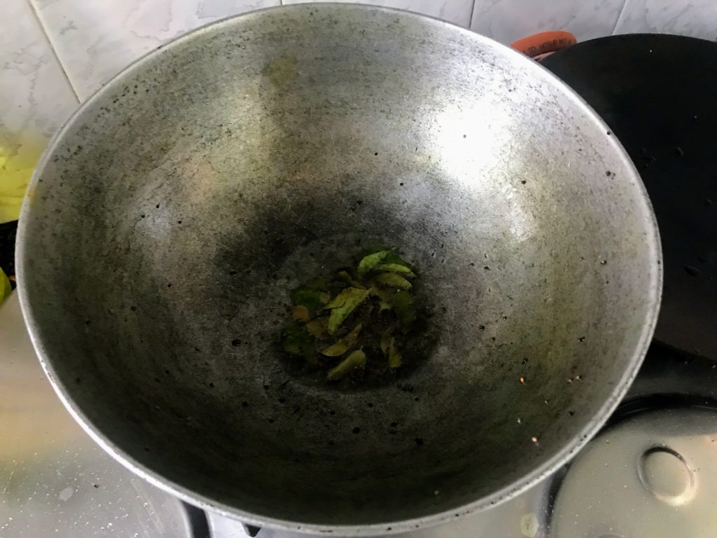 Tempering oil with mustard seeds and curry leaves