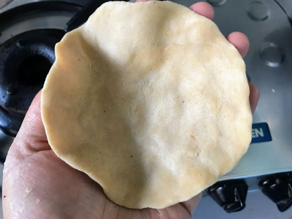 Flattened dough with hand