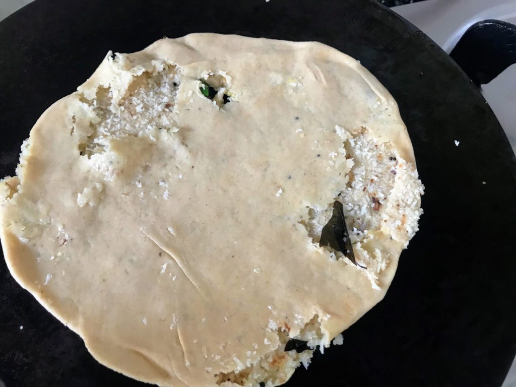 Cooking paratha on tawa