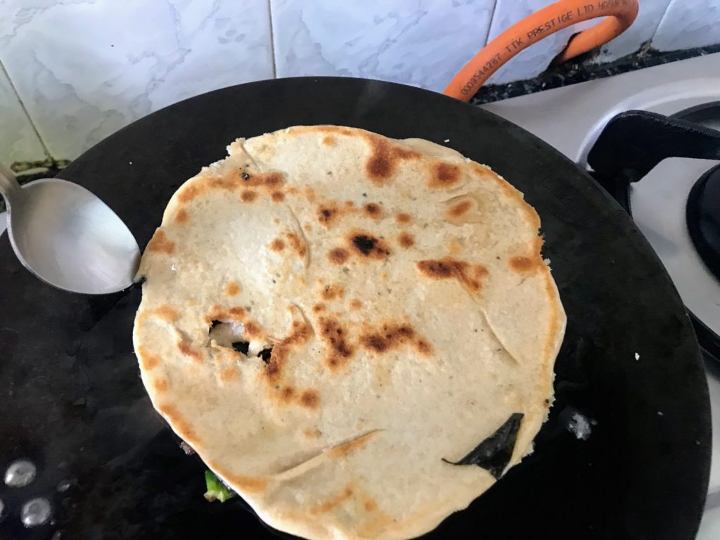 Cooking other side of paratha