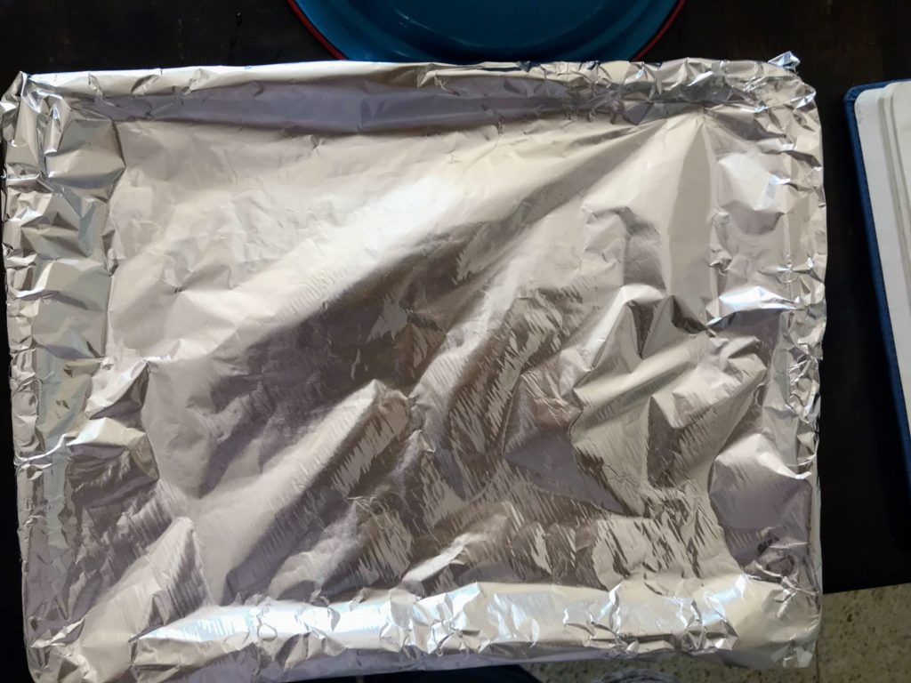 Oven tray wrapped in aluminium foil