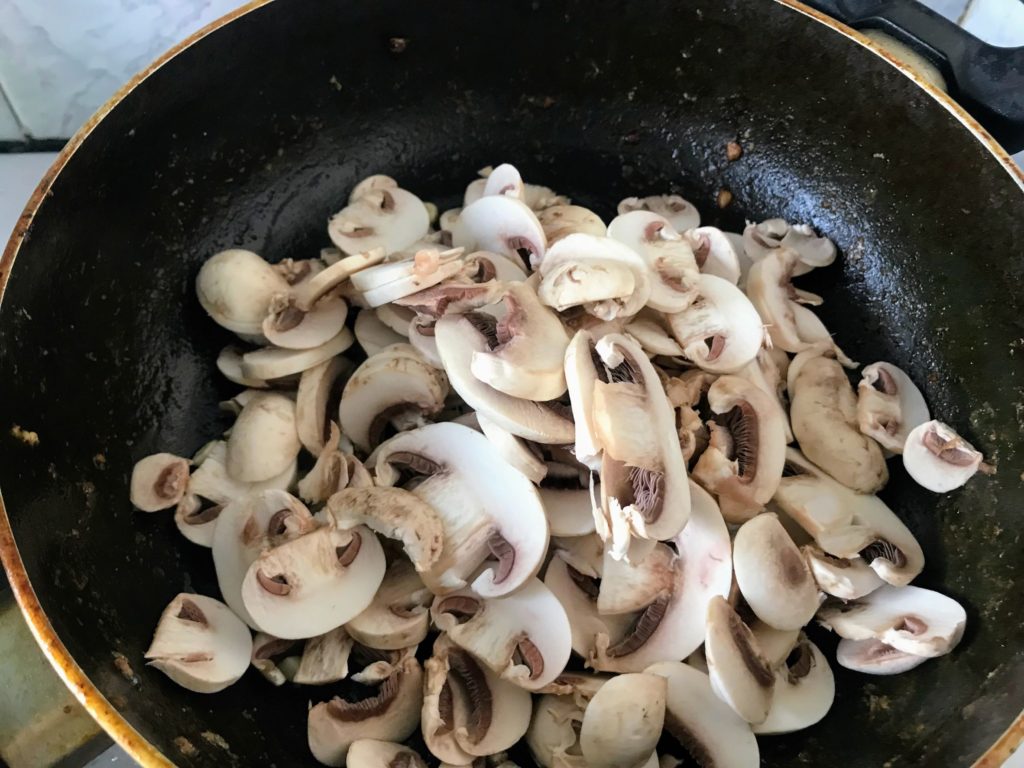 Sliced mushroom in pan for frying